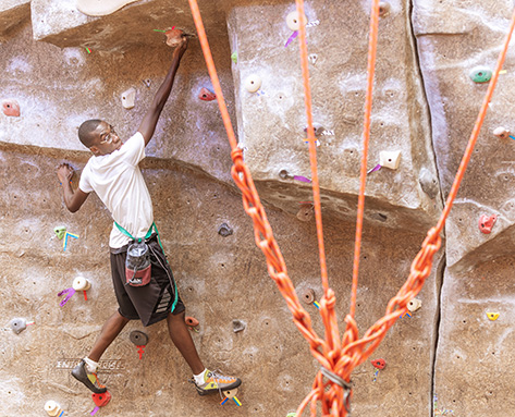 a student using the rock climbing wall in the West Center