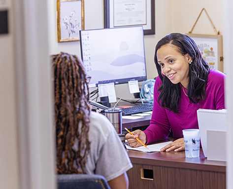 a student talking to an advisor in her office