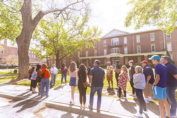 winthrop admissions ambassadors leading a tour for prospective undergraduate students
                  and their families