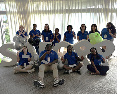 a group of students in matching blue shirts
